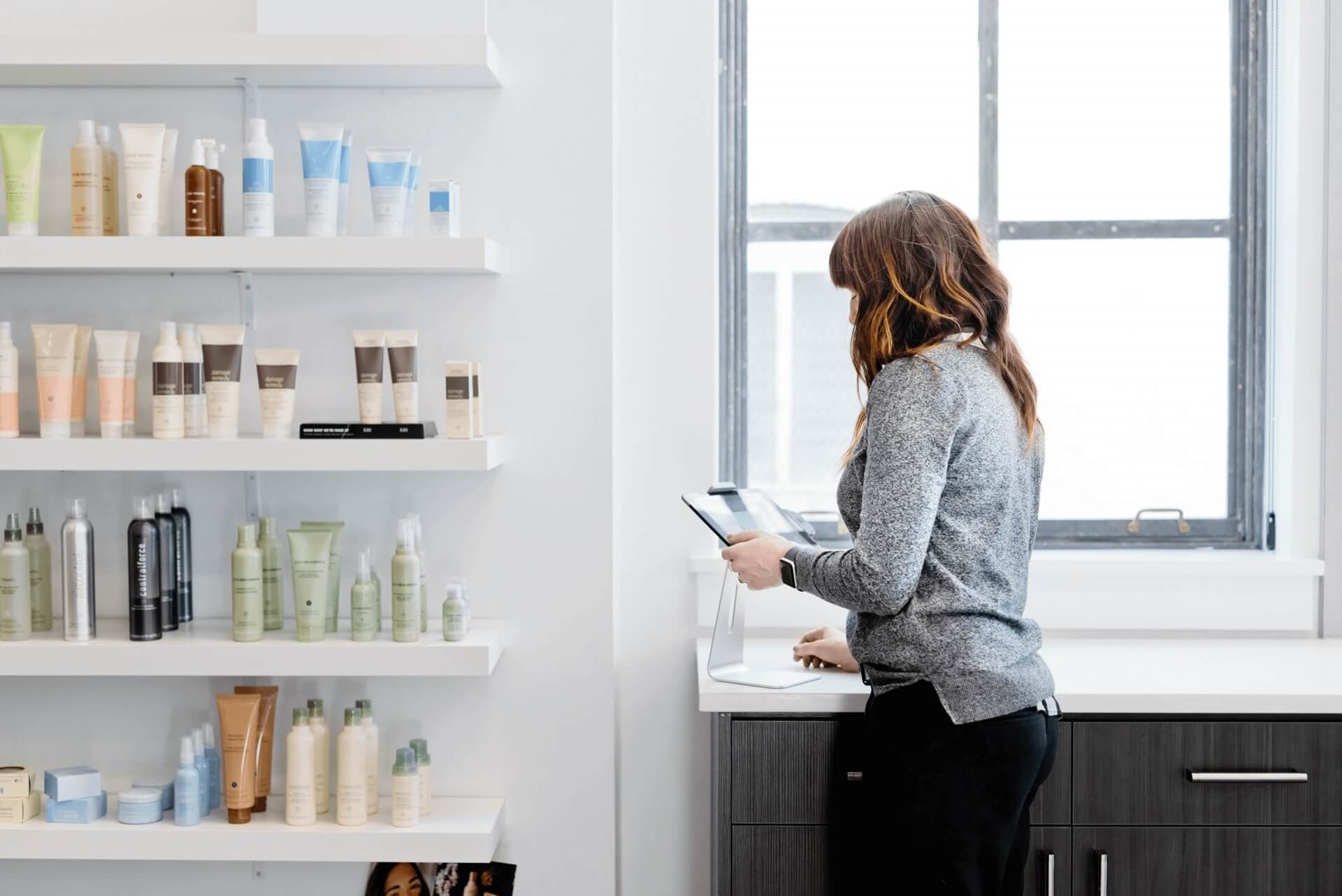 Vrouw met eenmanszaak (salon) checkt inventaris