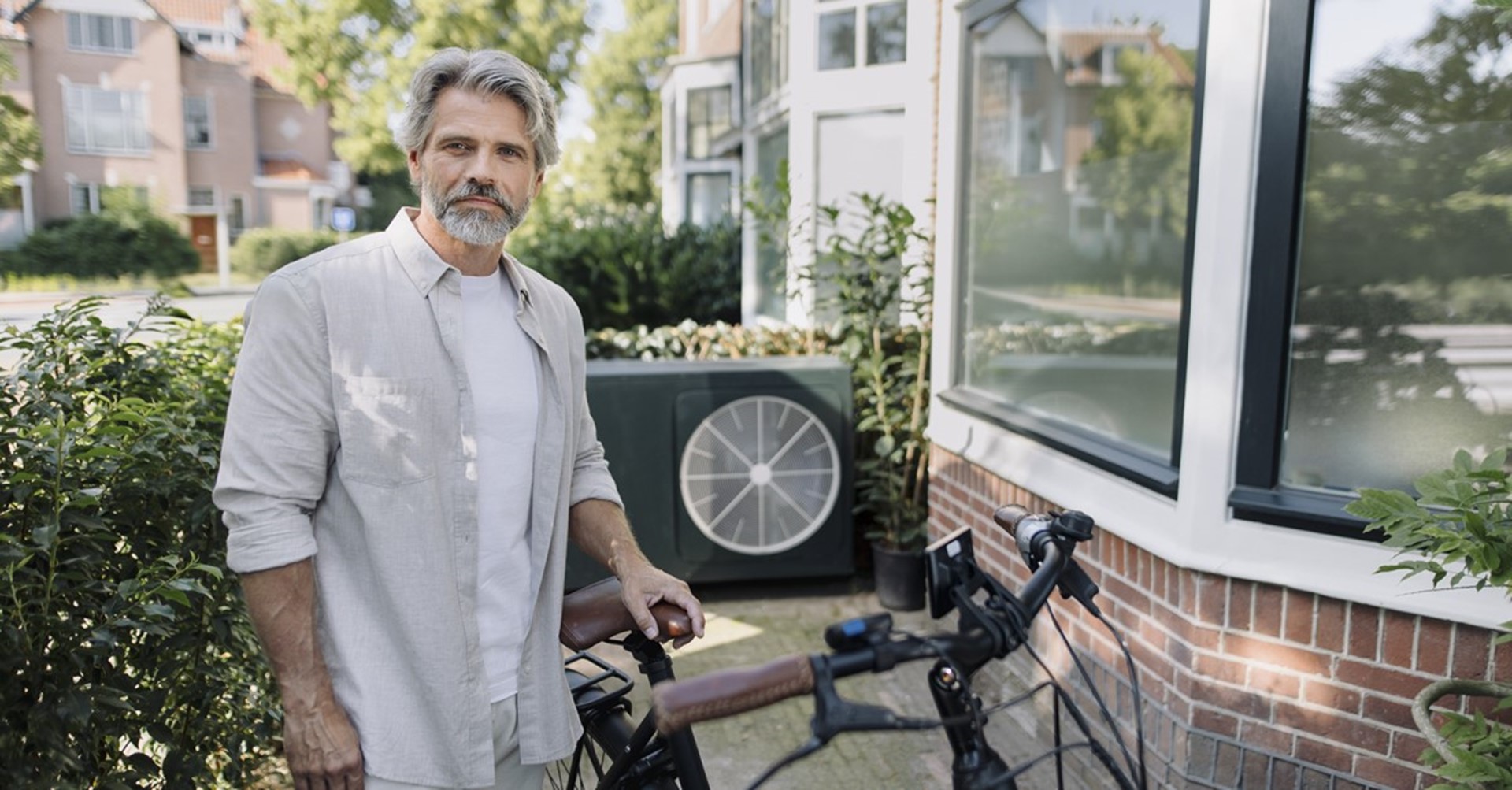 Man met fiets bij warmtepomp